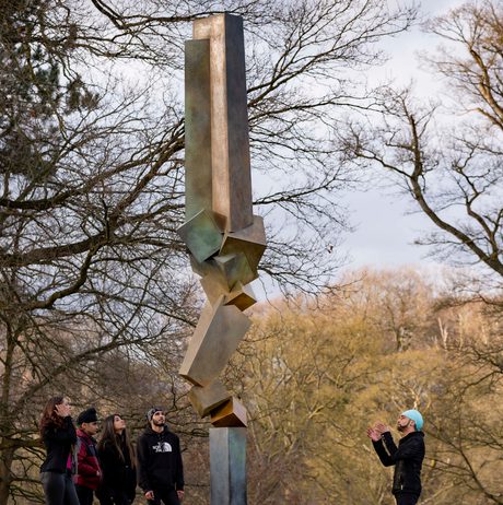 A group of people standing in front of Bruce Beasley Advocate IV, 1998, at Yorkshire Sculpture Park