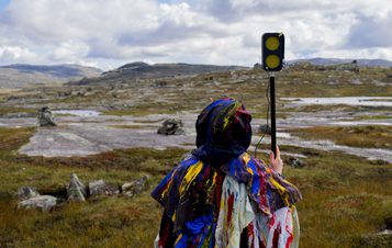 Someone holding a hand held microphone in the process of making Dillan Marsh and Eleanor Clare Woods - The Poacher’s Lament and Other Half Heard Tales 2019.