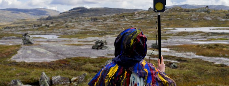 Someone holding a hand held microphone in the process of making Dillan Marsh and Eleanor Clare Woods - The Poacher’s Lament and Other Half Heard Tales 2019.