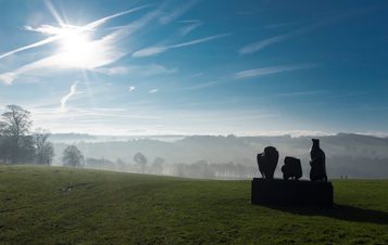 Silhouette of Henry Moore Three Piece Reclining Figure No 1 1961 at Yorkshire Sculpture Park