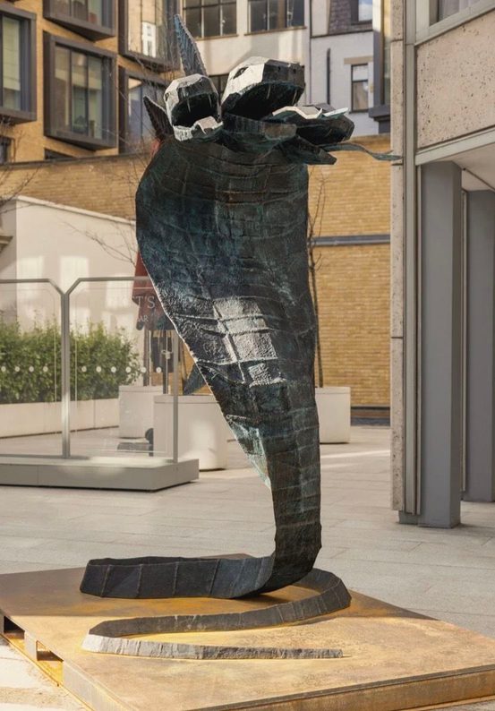 a sculpture of a three headed snake