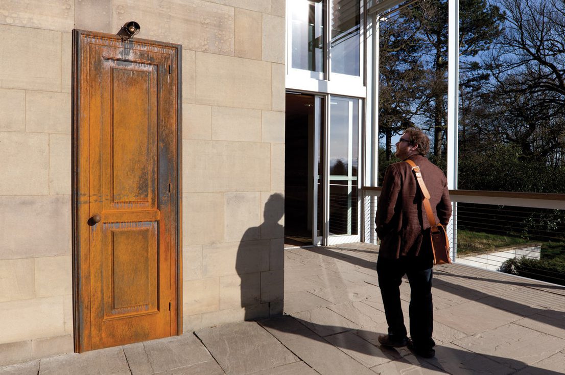 A white man standing in front of Jaume Plensa Wonderland 1993 at Yorkshire Sculpture Park