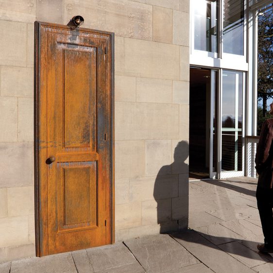 A white man standing in front of Jaume Plensa Wonderland 1993 at Yorkshire Sculpture Park