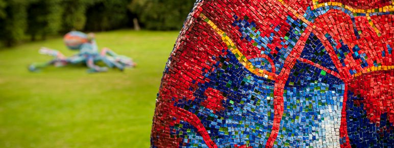 A close up of a red and blue mosaic sculpture