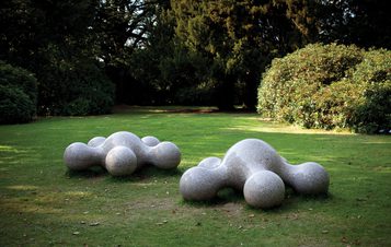 Two white blob-like sculptures with blobby limbs