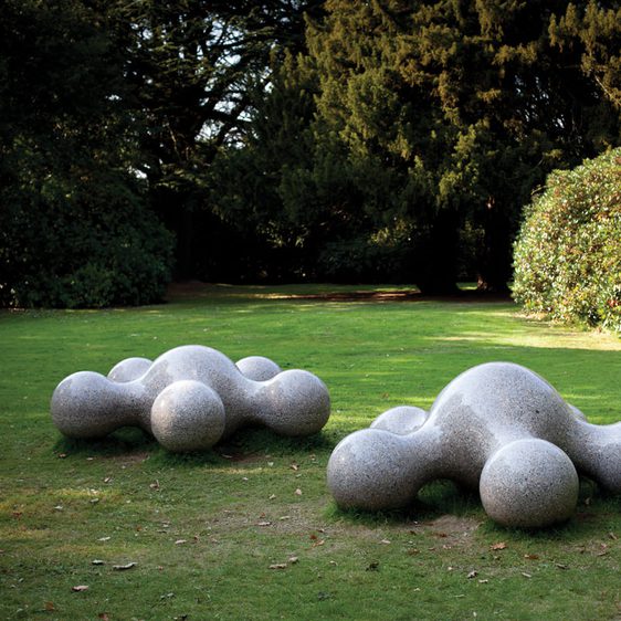 Two white blob-like sculptures with blobby limbs
