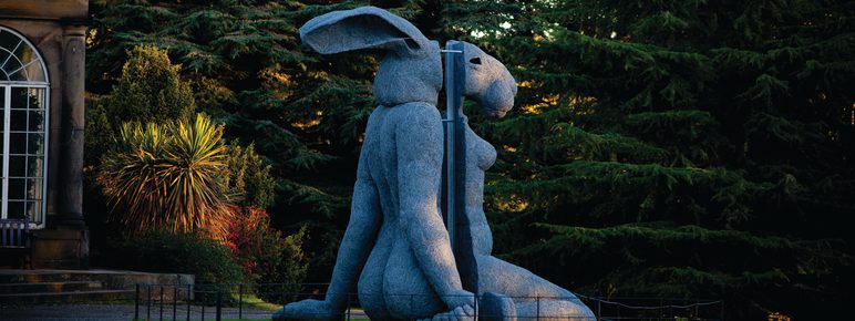 A sculpture with a woman's body and a rabbit head