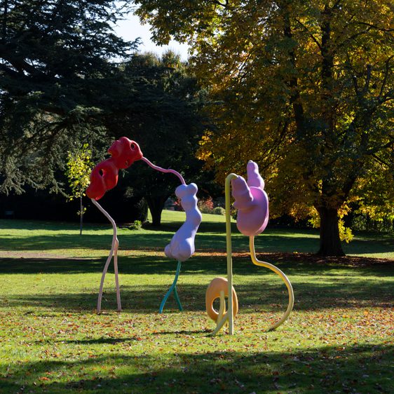 An abstract sculpture with colourful blob shapes and thin wiggly legs.