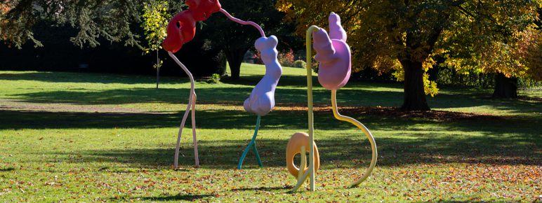 An abstract sculpture with colourful blob shapes and thin wiggly legs.