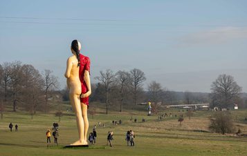 A large sculpture of a pregnant woman, with half her skin removed to reveal muscles and internal organs.