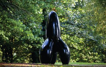 A tall rocket shaped black sculpture
