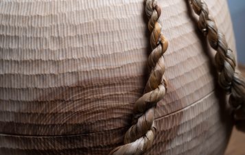 A close up of a carved wooden vessel