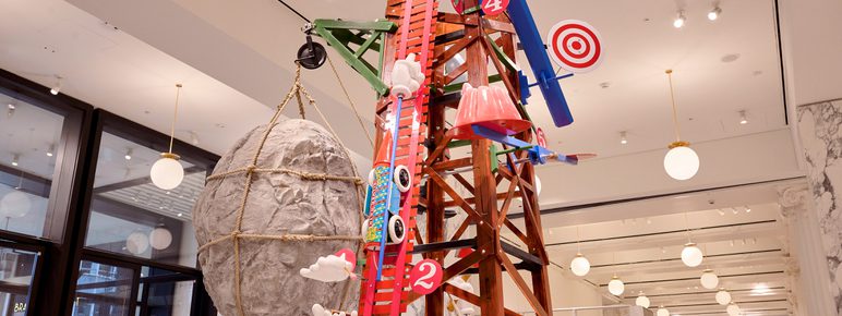 A colourful scaffolding structure with giant targets, models of cars, targets and giant rocks.