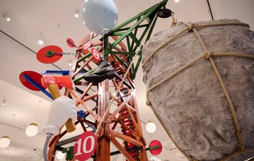 A colourful scaffolding structure with giant targets, models of hands, targets and rocks