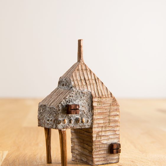A miniature carved wooden house