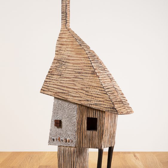 A miniature carved wooden house