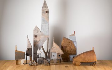 A group of carved wooden houses