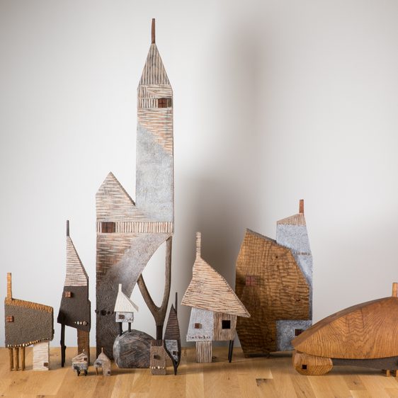 A group of carved wooden houses