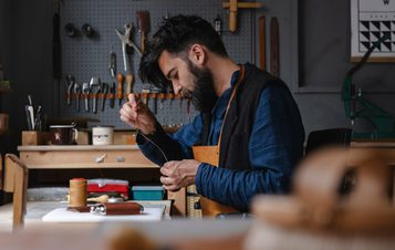 A bearded man, working in a studio