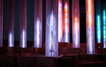 An installation of pink and blue glowing columns.