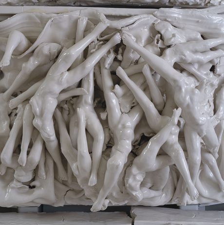 Porcelain tile of torsos and legs intertwined.