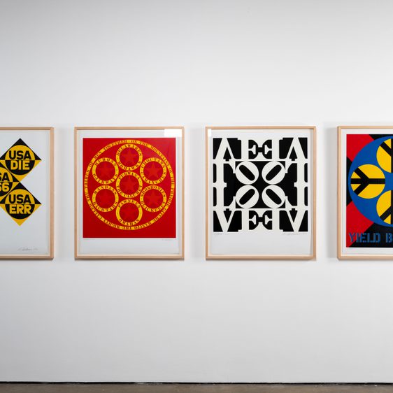 Four paintings hung in a row on the wall.