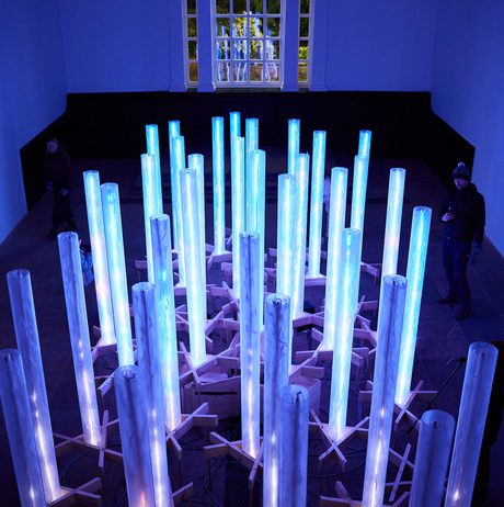 An aerial view of a series of blue glowing columns inside the Chapel