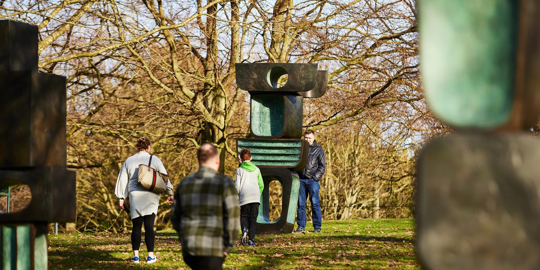 People looking at Barbara Hepworth's Family of Man.