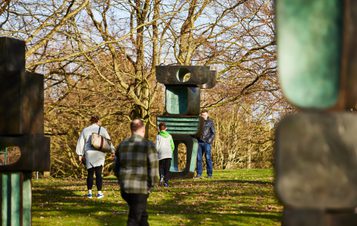 People looking at Barbara Hepworth's Family of Man.