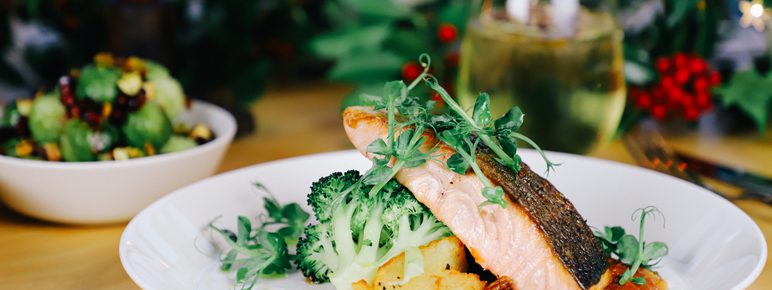 A plate of fish and seasonal vegetables.
