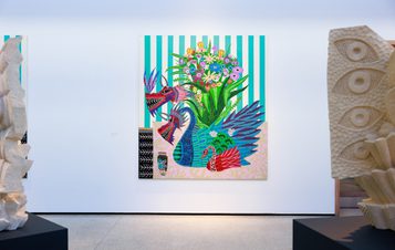 A vibrant artwork featuring a floral arrangement in a vase with a two headed dragon creature, set against a striped background. The piece is displayed in a gallery, with abstract sculptures on either side, enhancing the artistic atmosphere.