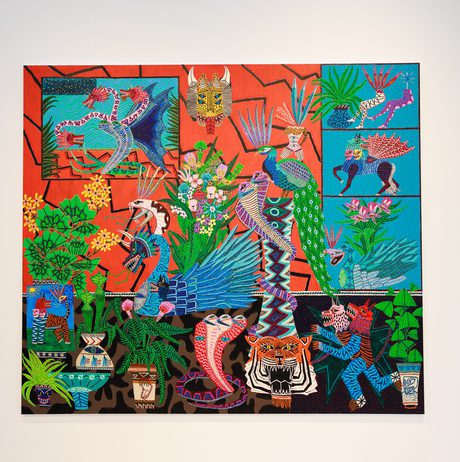 A vibrant, colourful painting featuring a variety of animals, plants, and human figures. The artwork is rich in detail, with intricate patterns and bold colours, depicting a lively scene that blends nature and culture in a dynamic composition.