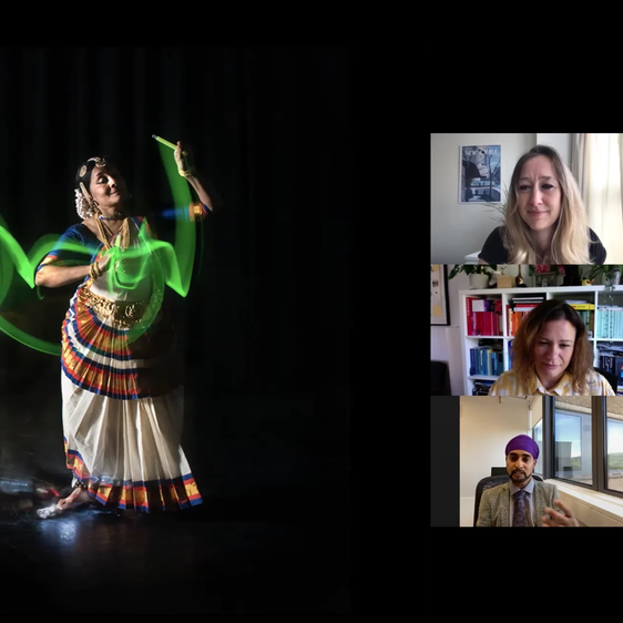 Three adults in an online zoom meeting, watching at a woman dancing on the screen.