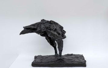 A bronze sculpture of a raven