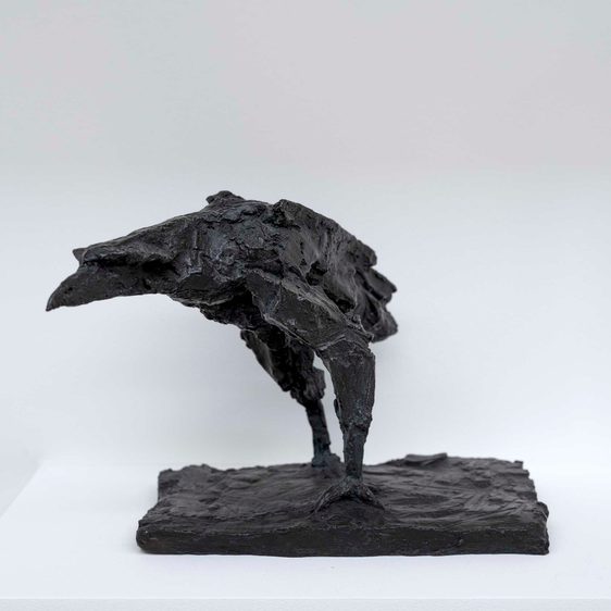 A bronze sculpture of a raven