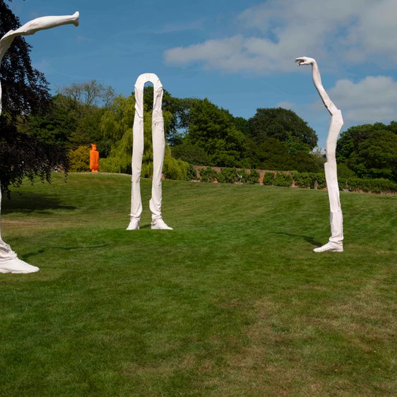 Three sculptures outside of elongated legs and arms