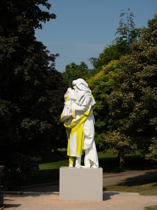 A white and yellow sculpture stood on a plinth.
