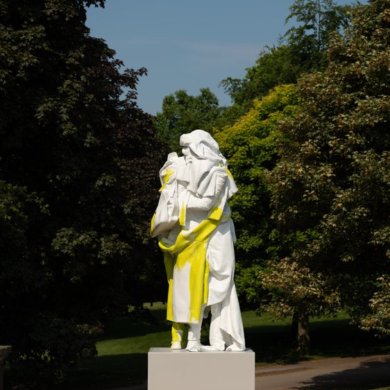 A white and yellow sculpture stood on a plinth.