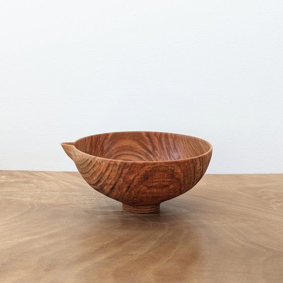 Small wooden vessel with a pouring spout