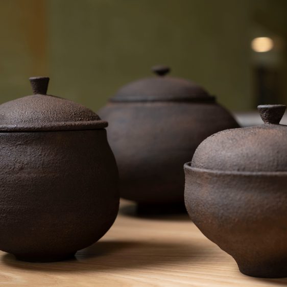Dark wooden vessels with lids