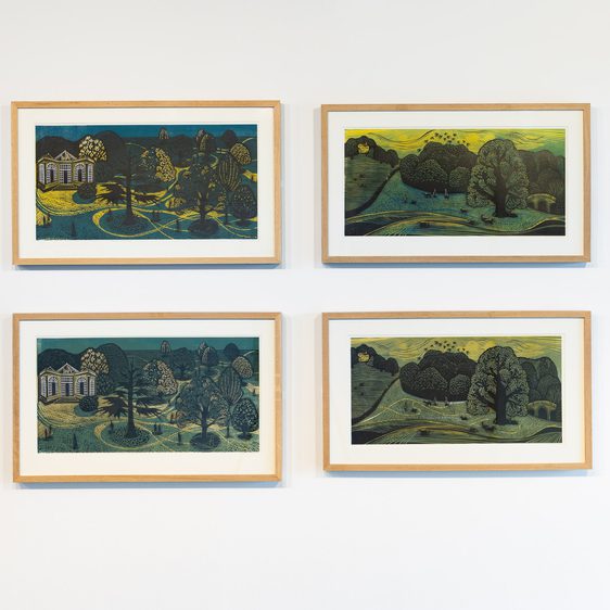 Four framed lino cut prints of landscapes on a white wall.