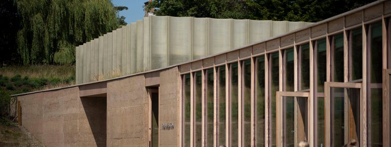 A couple of visitors sat at tables, enjoying their drinks outside The Weston in the sunshine.