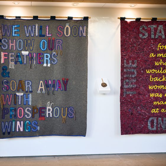 A display of fabric banners with appliquéd lettering