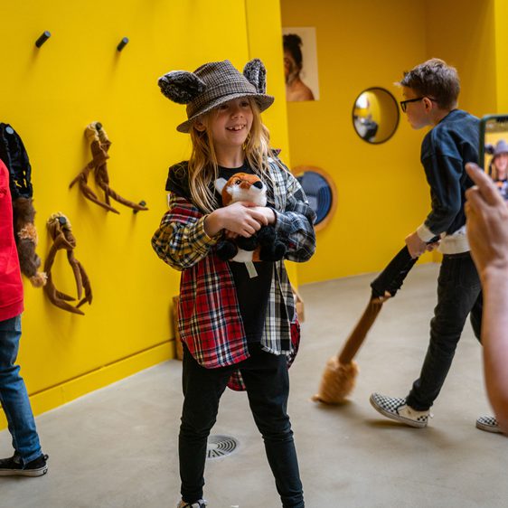 Children dressing up with animal ears and tails having their photograph taken