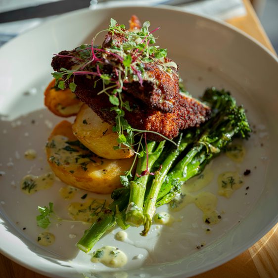 A plate of meat and seasonal vegetables