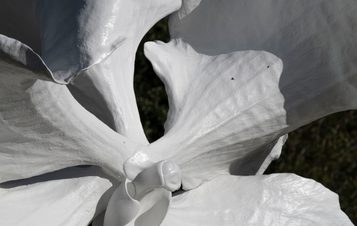 Detail of a sculpture of a white orchid flower.