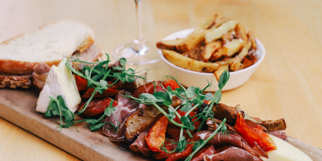 A board of cheese and charcuterie meats.