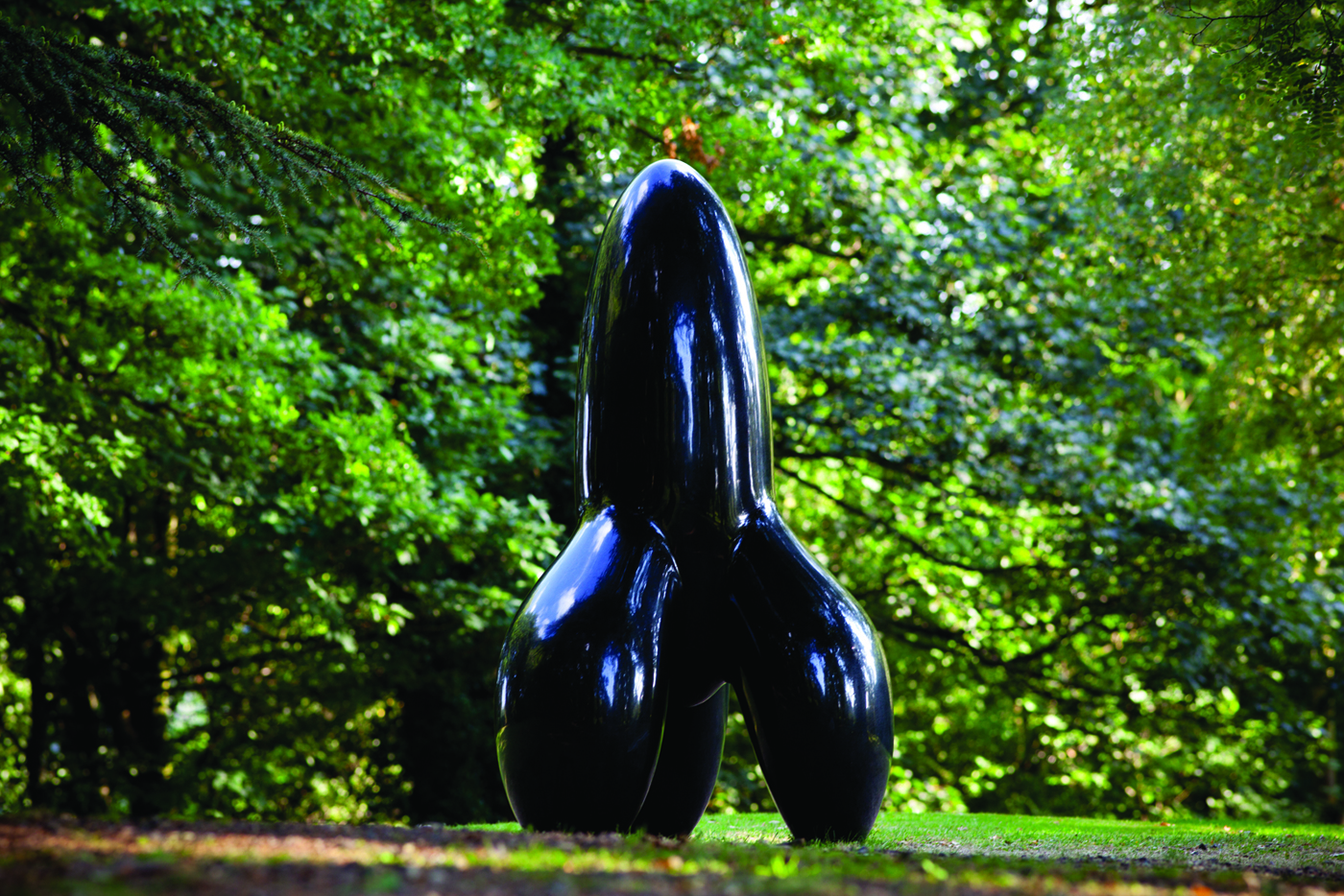 A tall rocket shaped black sculpture